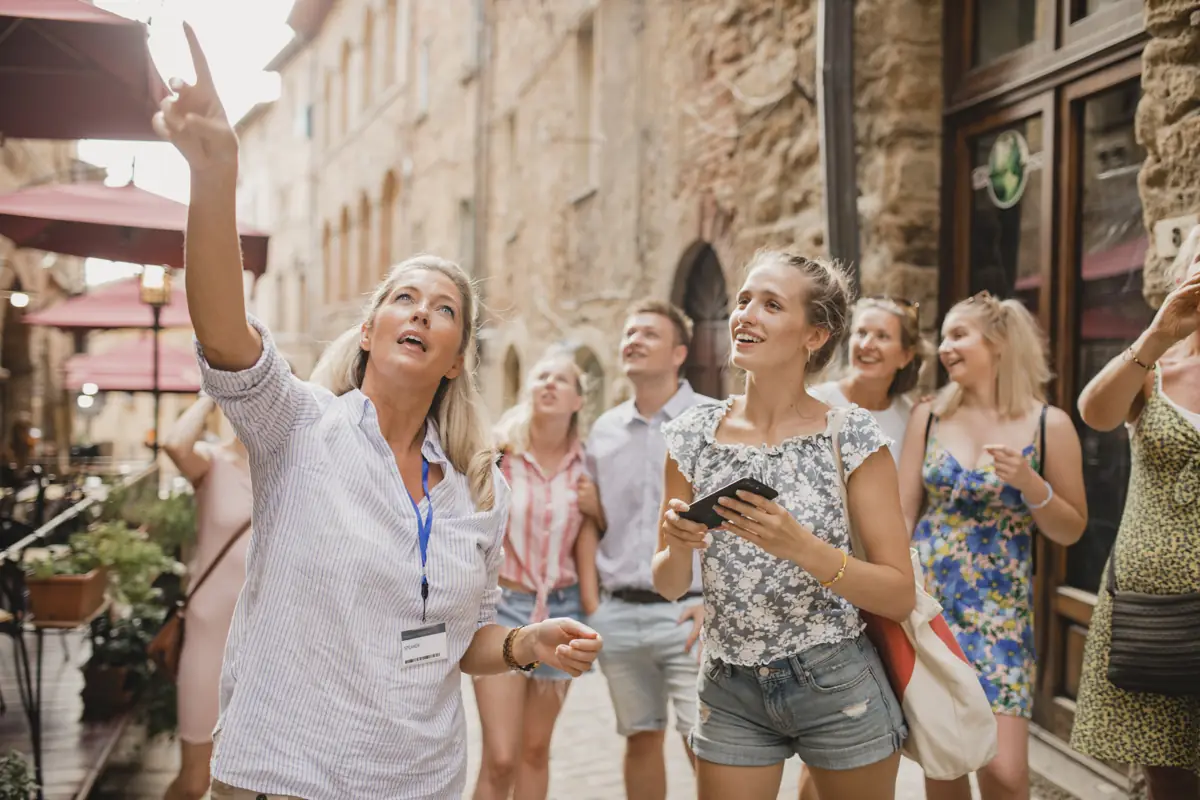 Local guide leading a group through the streets of an old town