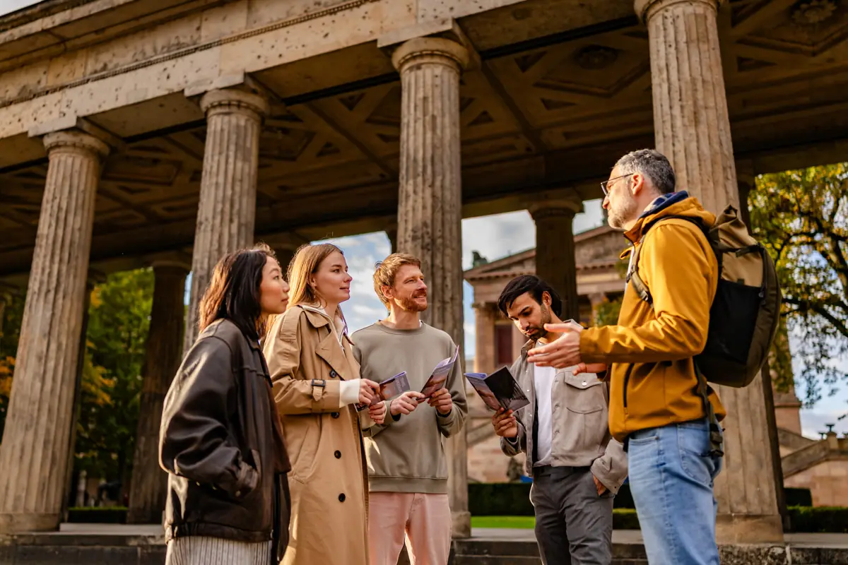Local guide talking to a small group under a colonnade
