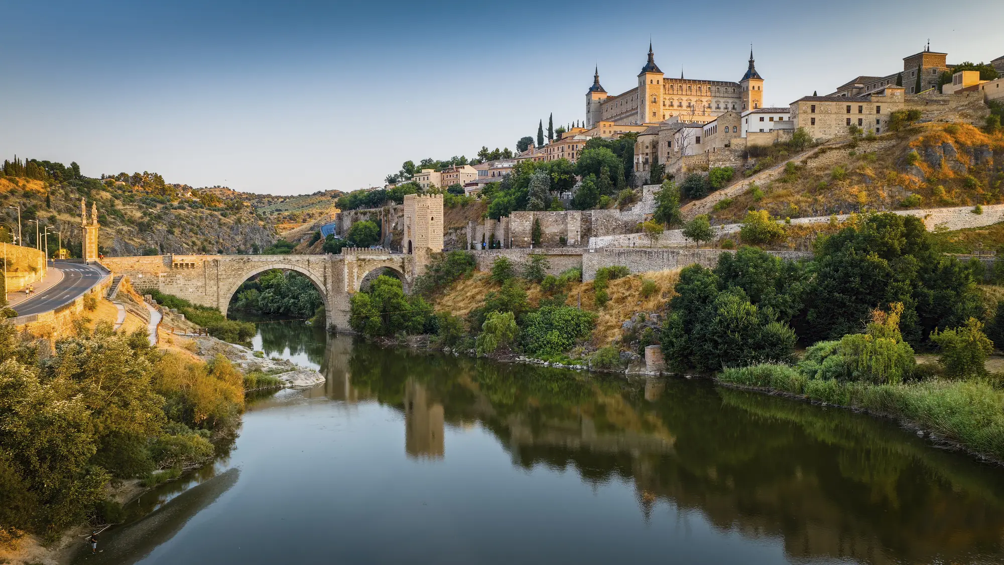 Toledo above the Tagus river with the Alcántara bridge and the Alcázar