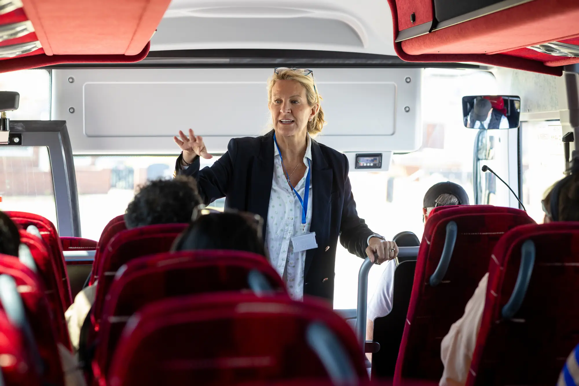 Tour leader briefing a group on board a coach